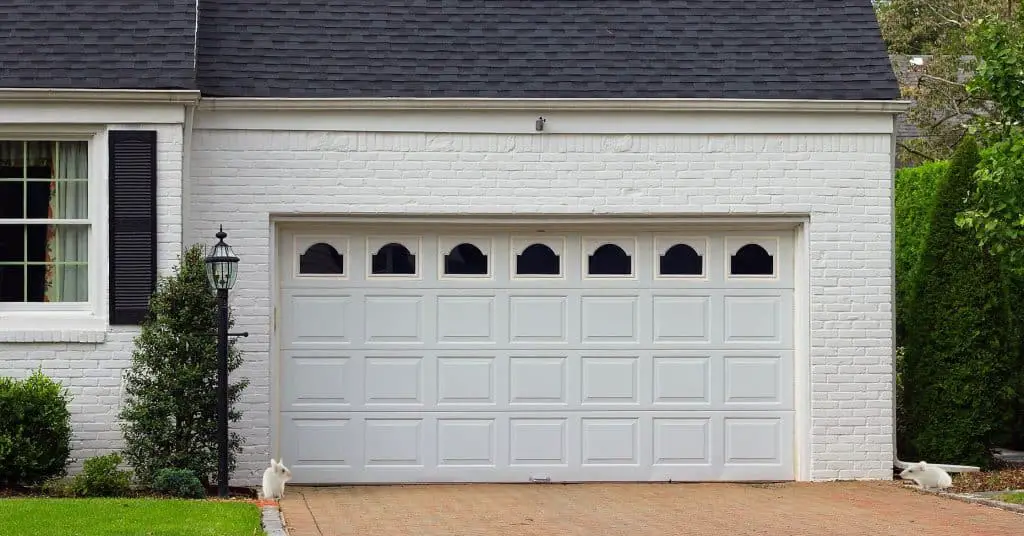 View from the driveway with 2 little rodents trying to get in through the garage door.